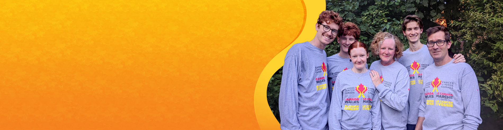 A lovely family wearing the Long Sleeve Heather Grey Shirt with the Bladder Cancer Canada Logo